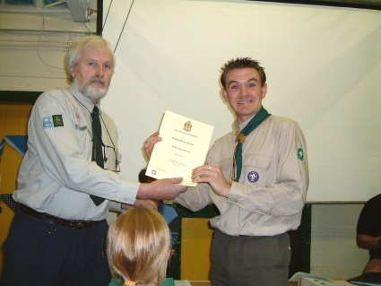 Akela (Rob Harris) Receiving his Service Certificate from Ray Tucker